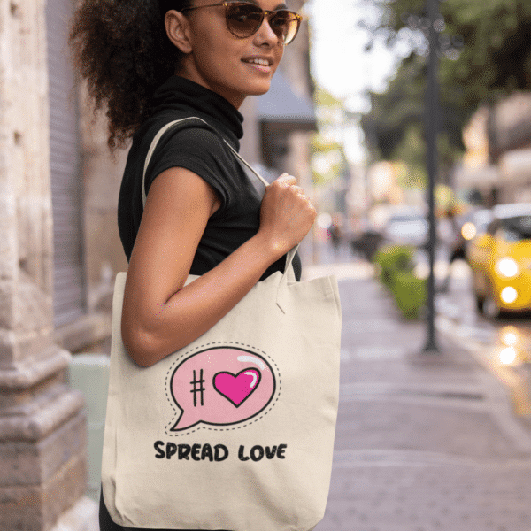 Black model modeling Spread Love Tote Bag in the city