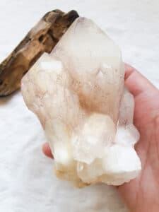 Candle Quartz in hand with Palo Santo. How to pick the right stone for crystal healing.