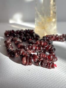 Raw Garnet beads with polished quartz tower. Garnet is a crystal that helps with passion.